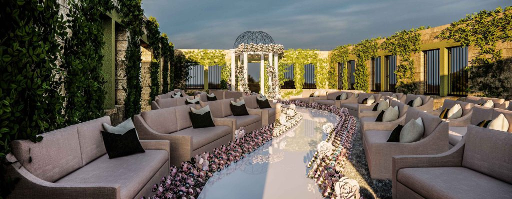 Outdoor wedding aisle lined with flowers leading to a floral gazebo, with lounge seating on either side